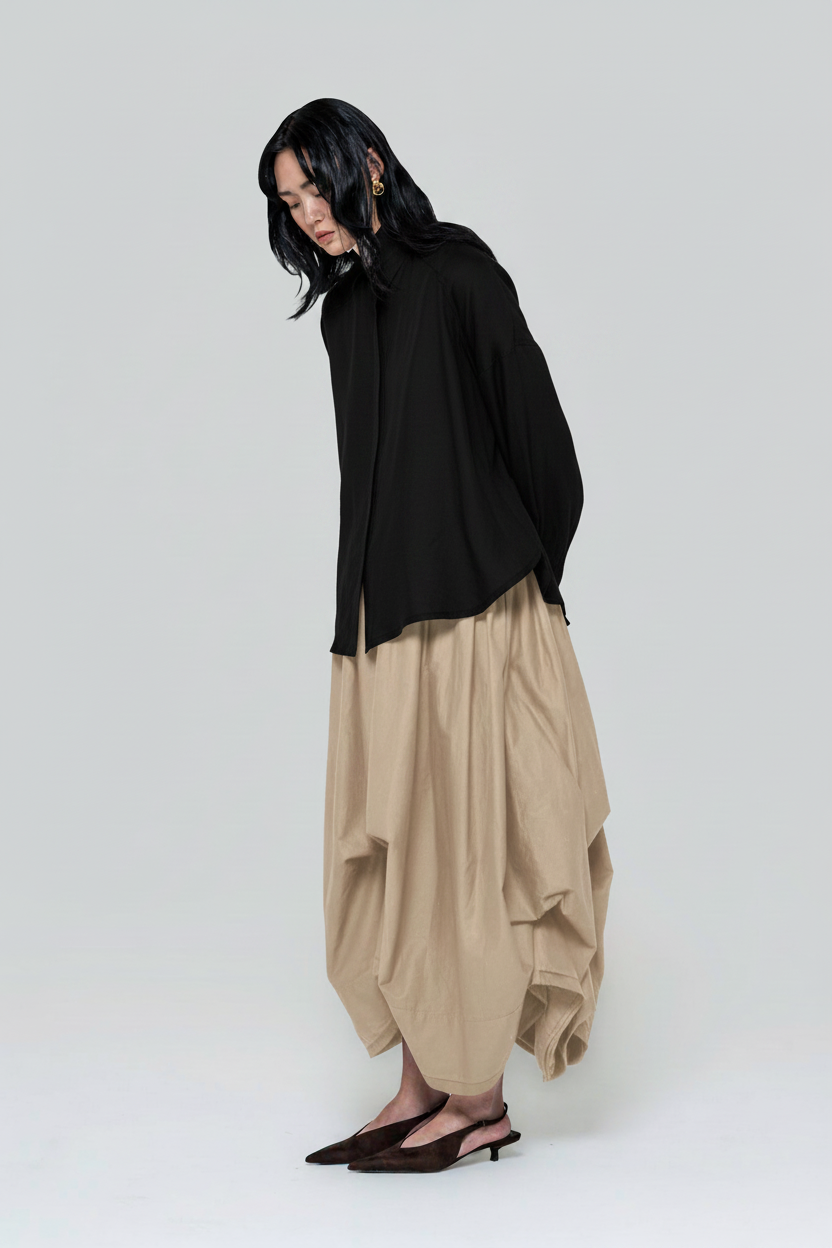 Fashion image with a black shirt and beige skirt